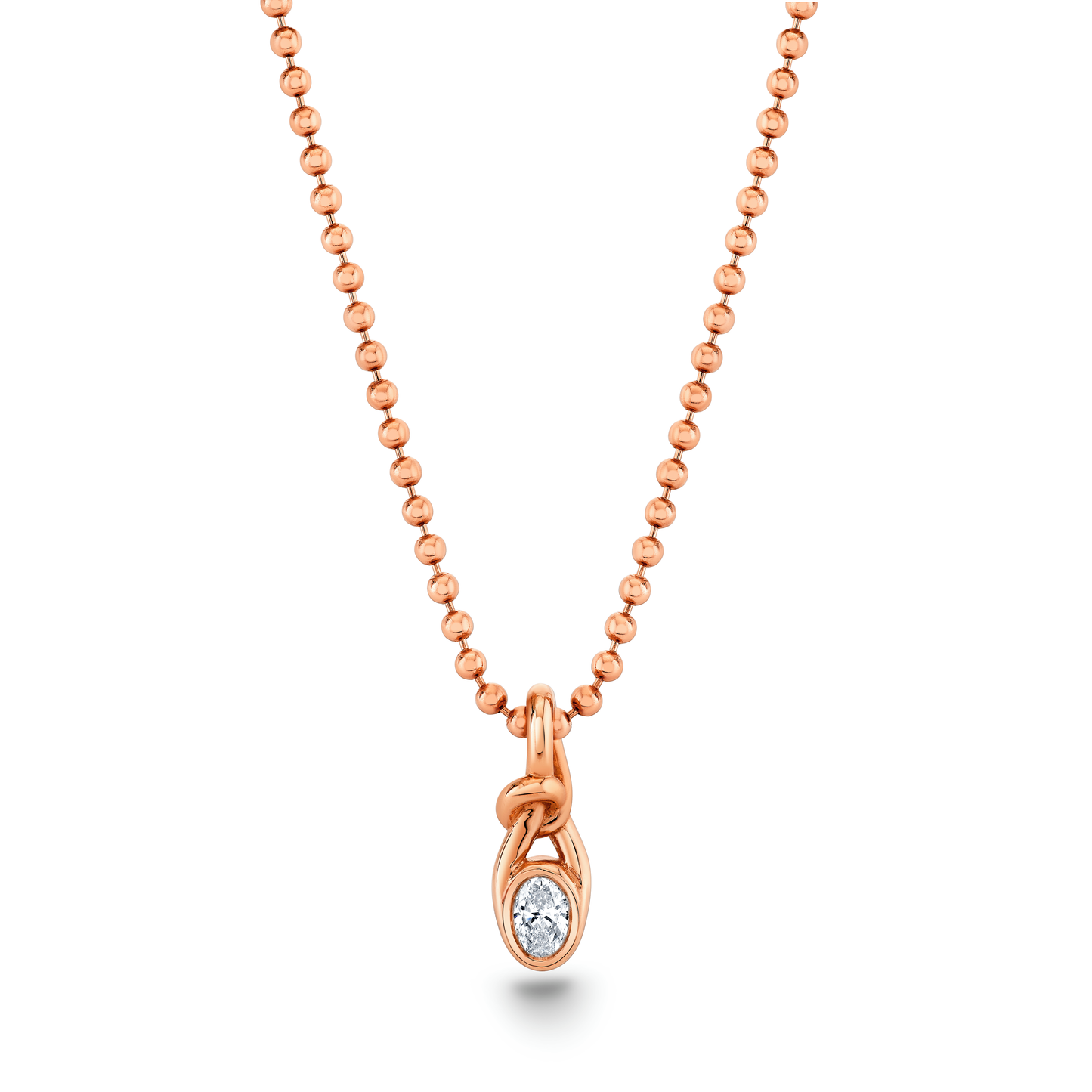 An oval knot pendant with a bezel setting containing a small diamond, attached to a 18k rose gold ball chain by Norman Silverman