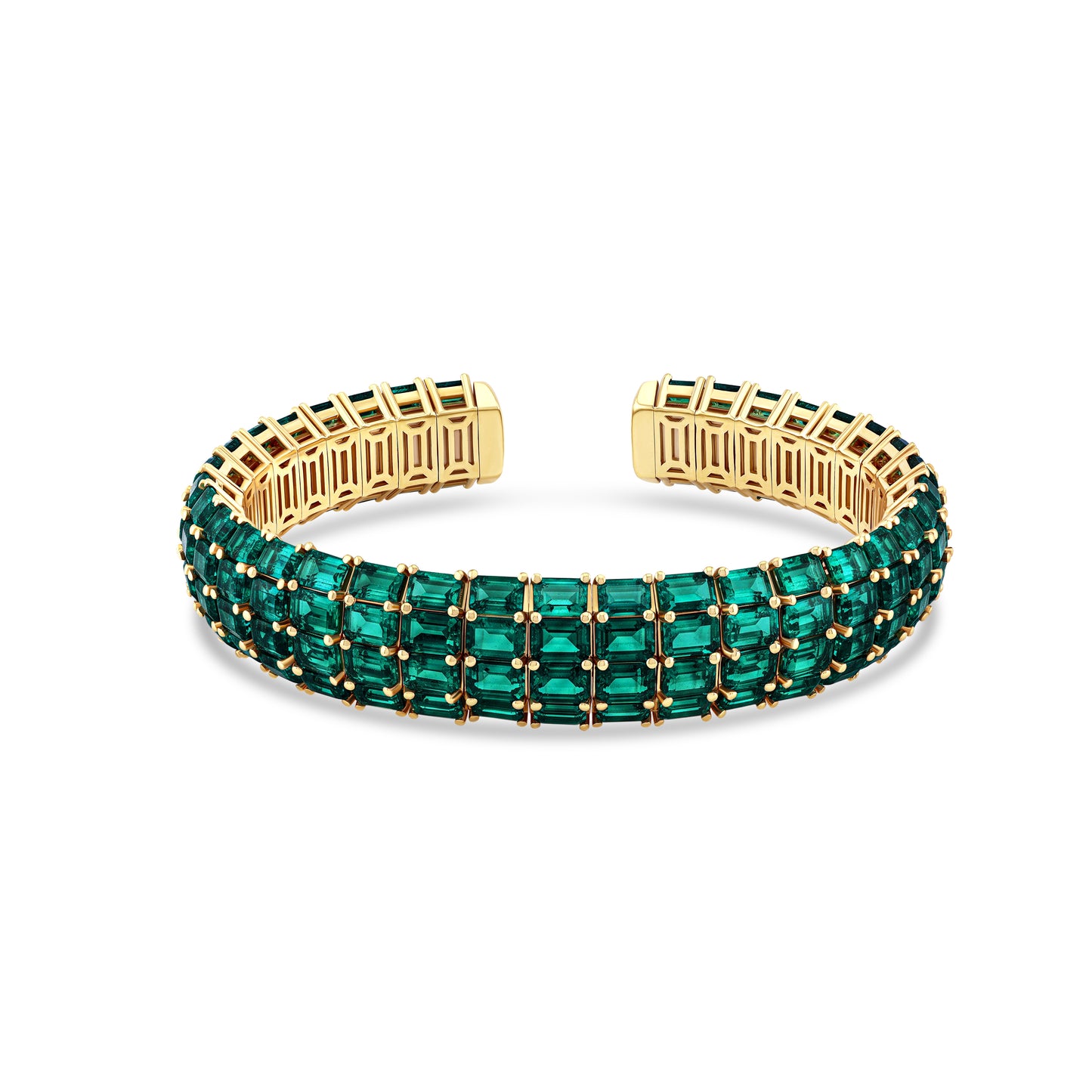 A gold cuff bracelet featuring three rows of emeralds, set against a clean white background.