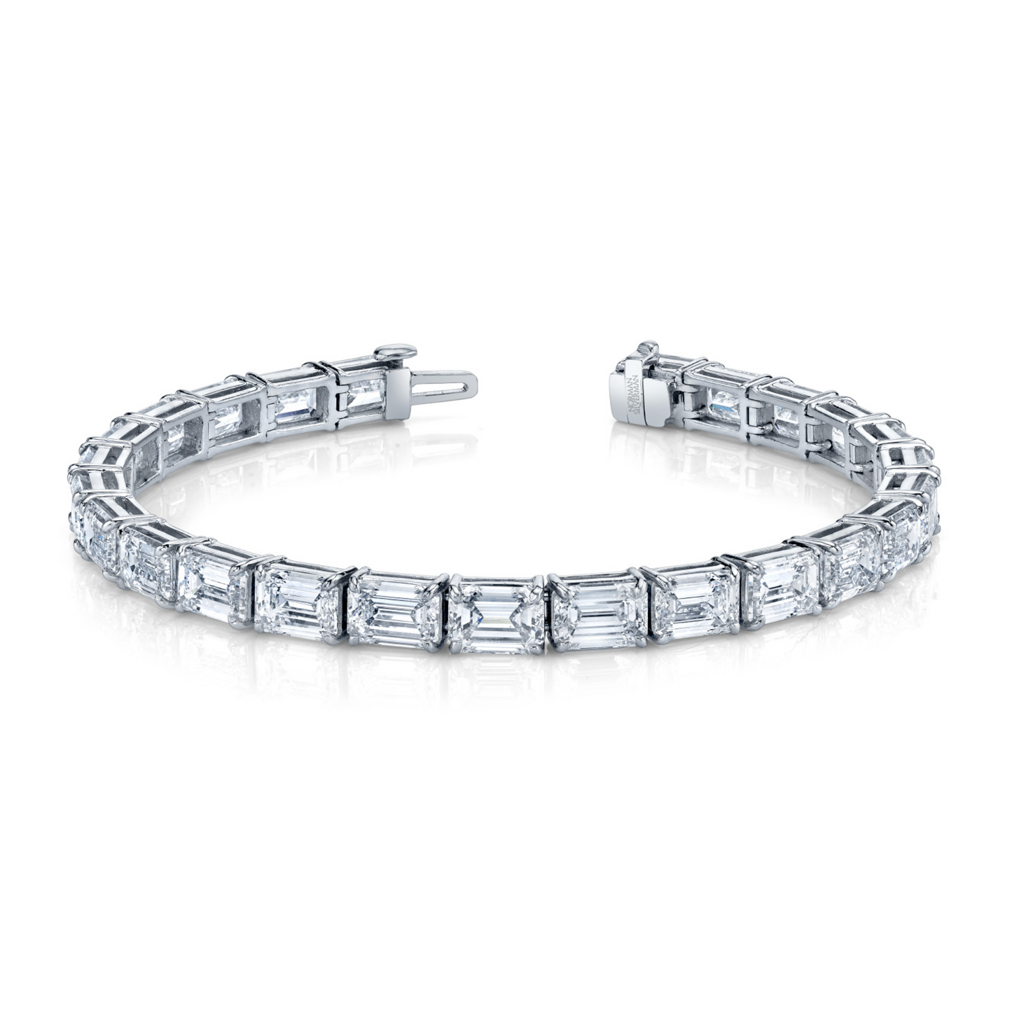 A straight line bracelet featuring emerald cut diamonds set in platinum.