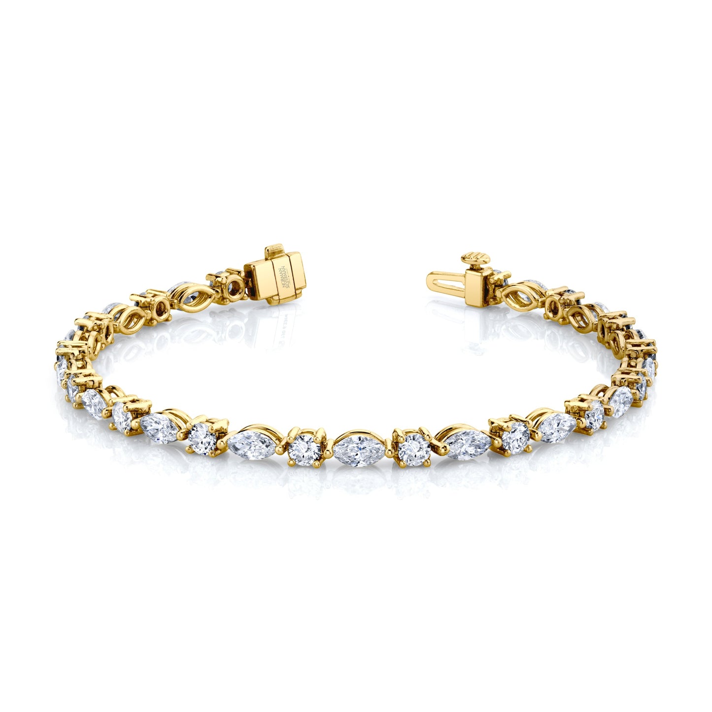 A Norman Silverman bracelet featuring alternating marquise and round brilliant cut diamonds set in 18k yellow gold.