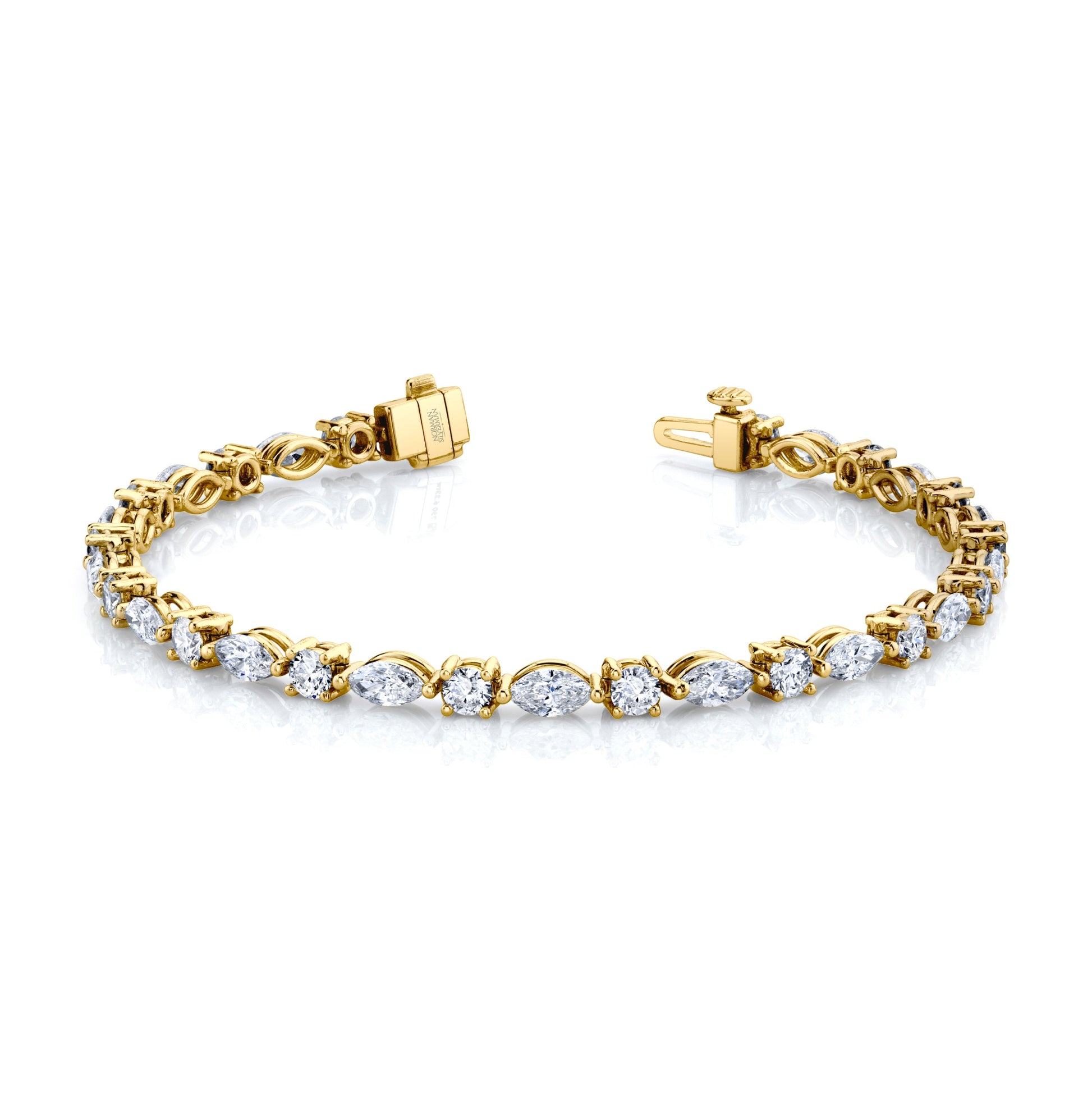 A Norman Silverman bracelet featuring alternating marquise and round brilliant cut diamonds set in 18k yellow gold.