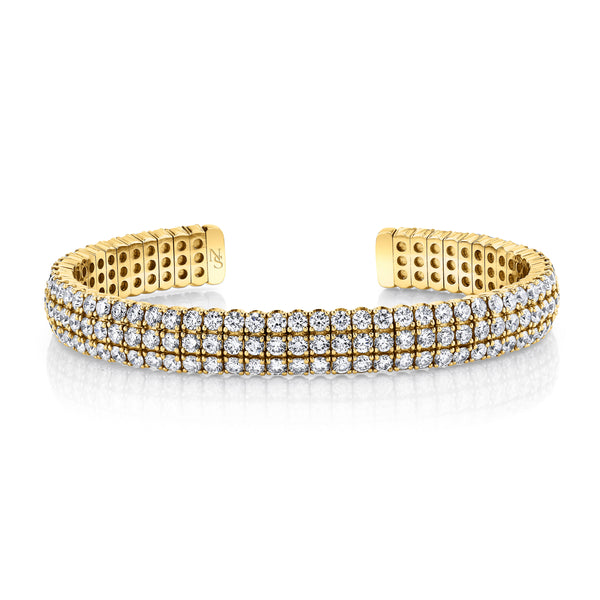 Gold bangle bracelet with diamonds.