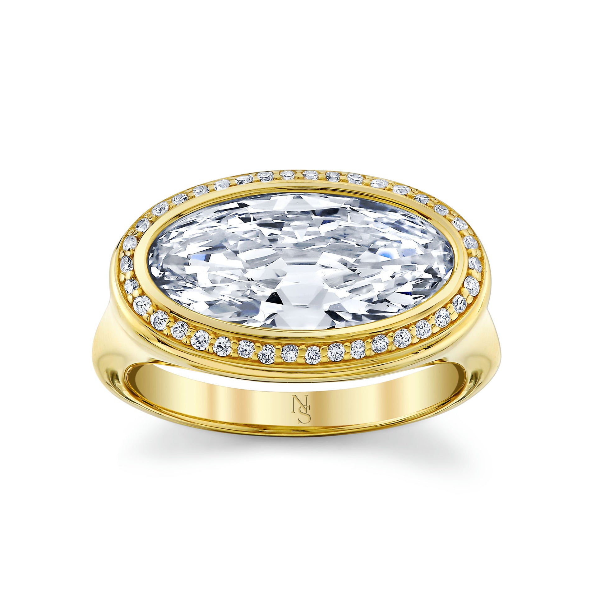 An oval cut diamond halo ring with a yellow gold band and smaller diamonds around the main stone.