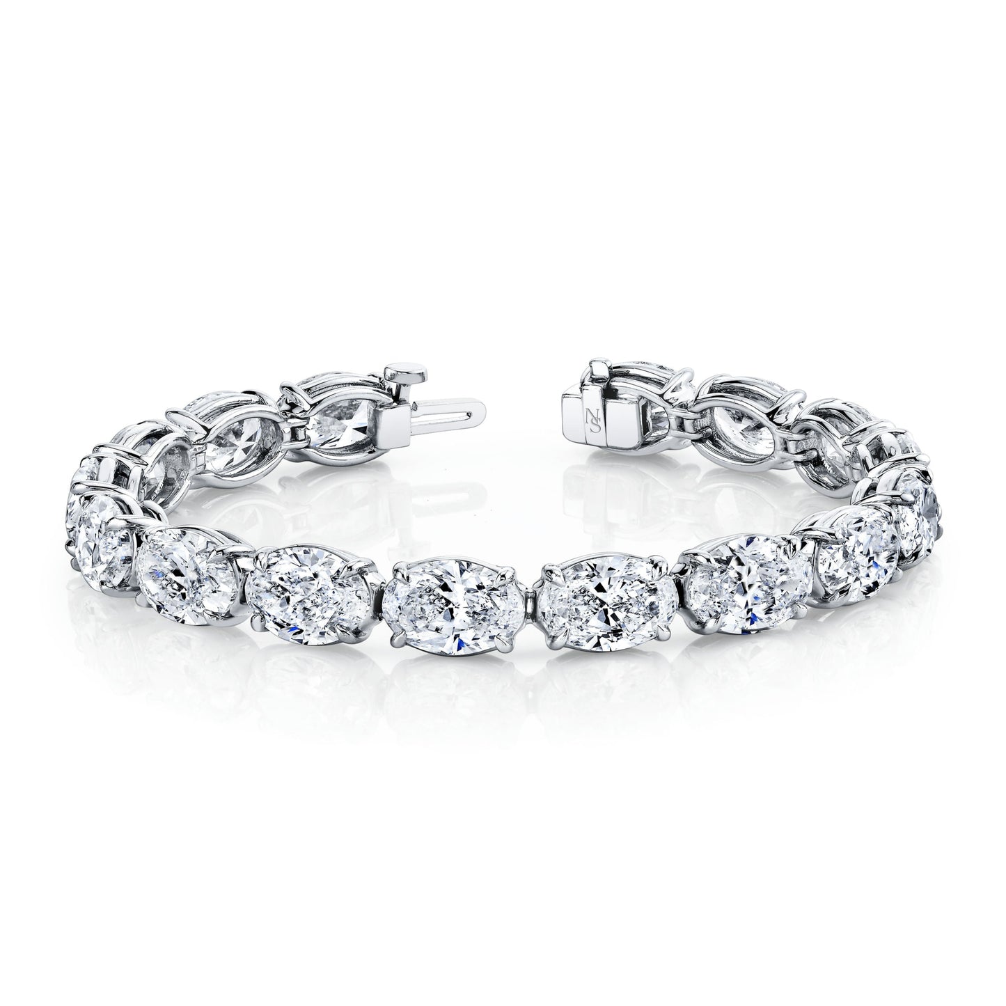 A platinum bracelet featuring a row of oval-shaped diamonds set in a straight line.