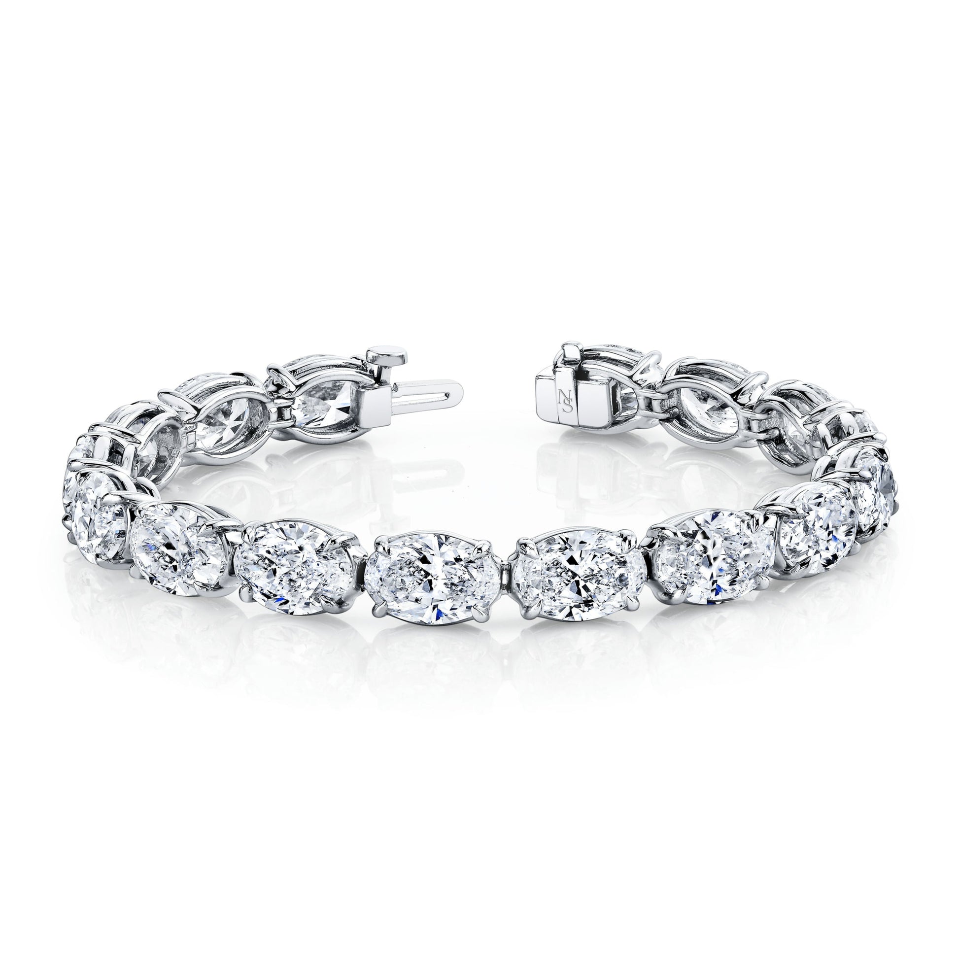 A platinum bracelet featuring a row of oval-shaped diamonds set in a straight line.