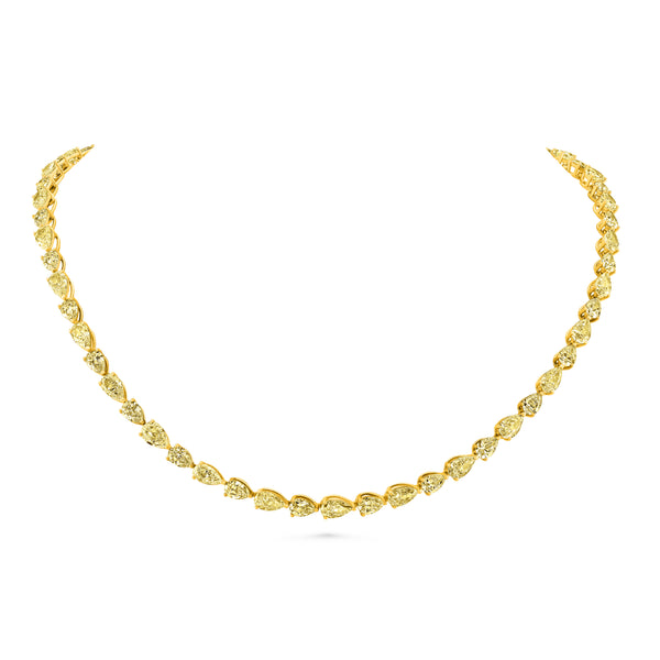Gold tennis necklace with east west pear yellow diamond on a white background