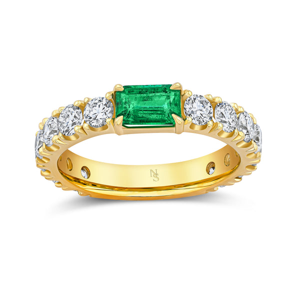 Gold ring with a green gemstone and white diamonds.