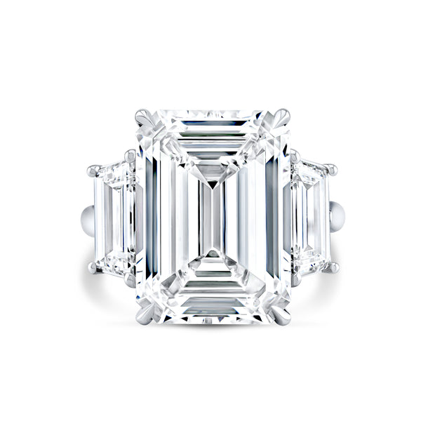 A 13.18 Carat Emerald Cut Three Stone Diamond Engagement Ring set in platinum.