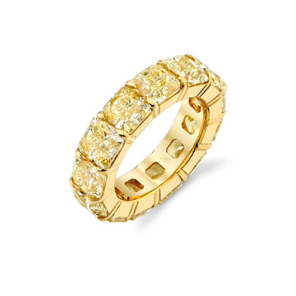 An 18K yellow gold eternity band featuring Fancy Yellow Radiant Cut diamonds