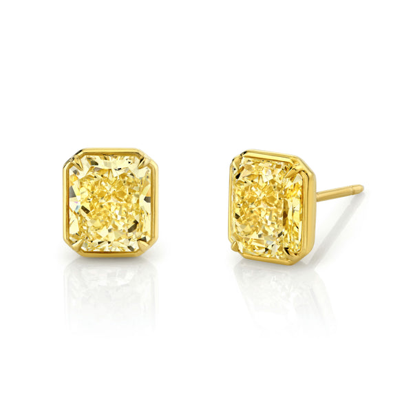 A pair of 18k yellow gold stud earrings featuring radiant-cut yellow diamonds.