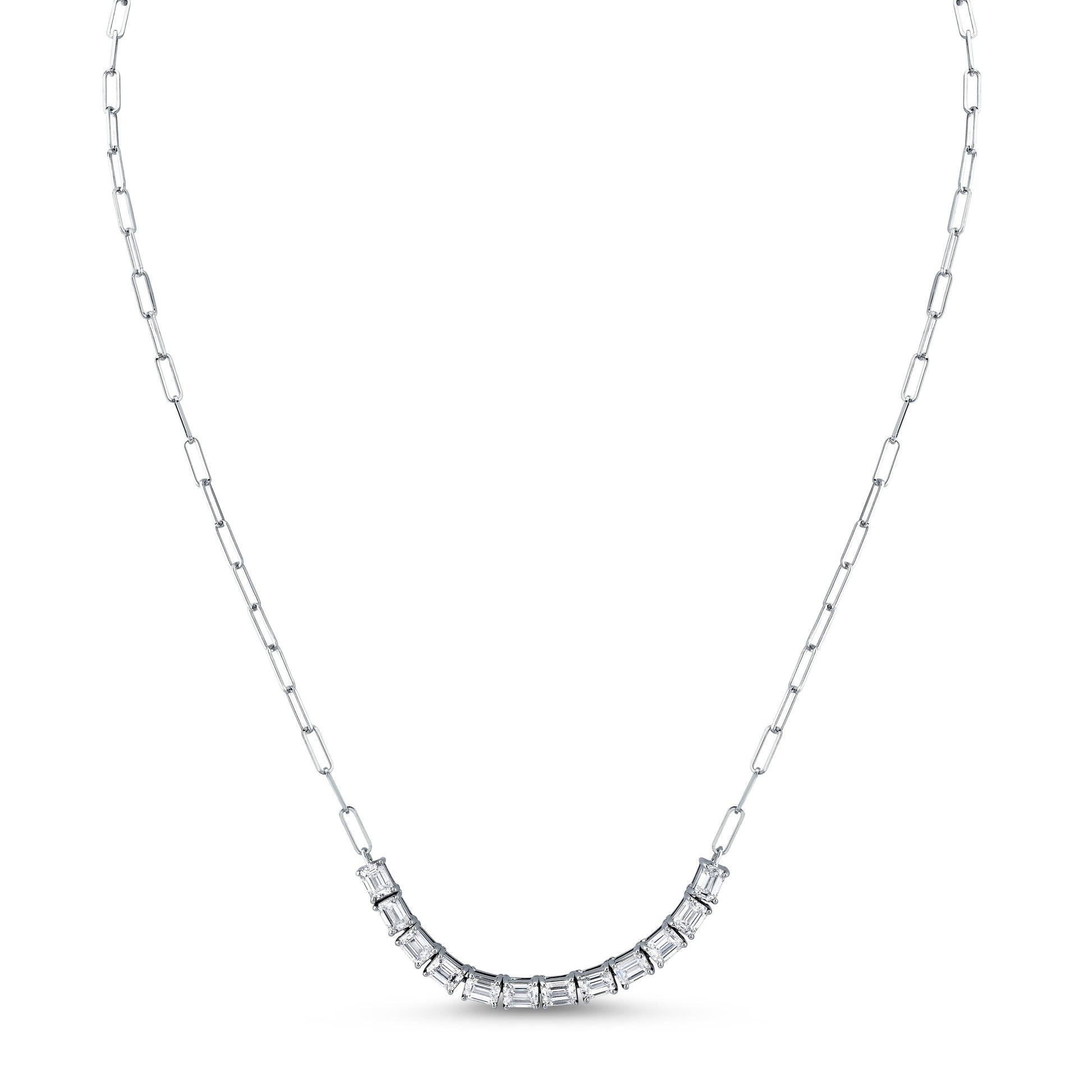 An 18k gold pendant necklace featuring an emerald cut diamond, attached to a paperclip chain by Norman Silverman