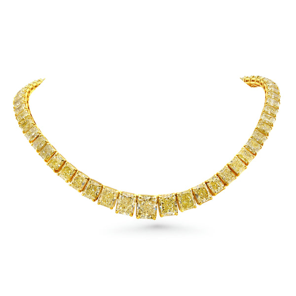 A graduated fancy yellow radiant cut diamonds necklace in 18k yellow gold.