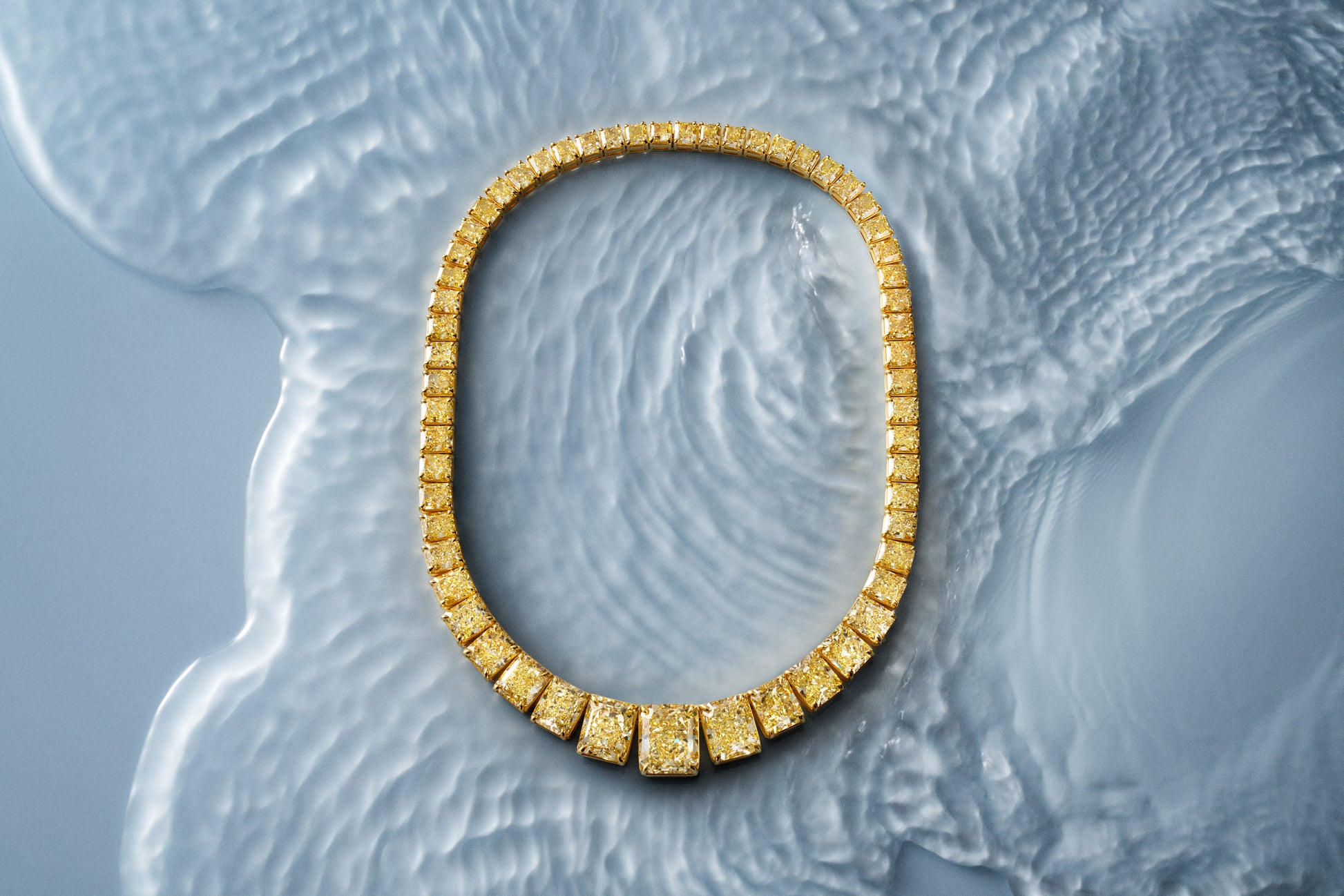 Gold necklace with graduated fancy yellow diamonds.