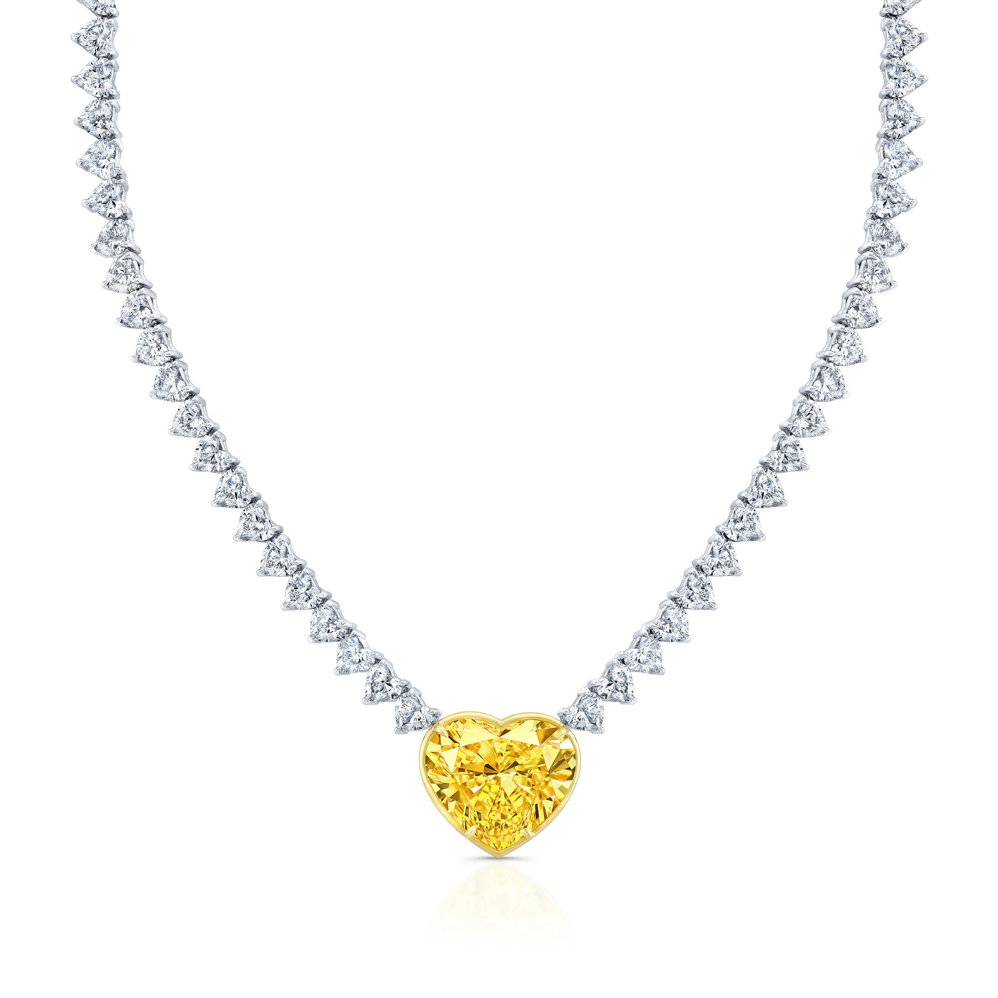 A heart-shaped diamond necklace with a fancy yellow center stone, surrounded by a line of smaller heart-shaped diamonds.