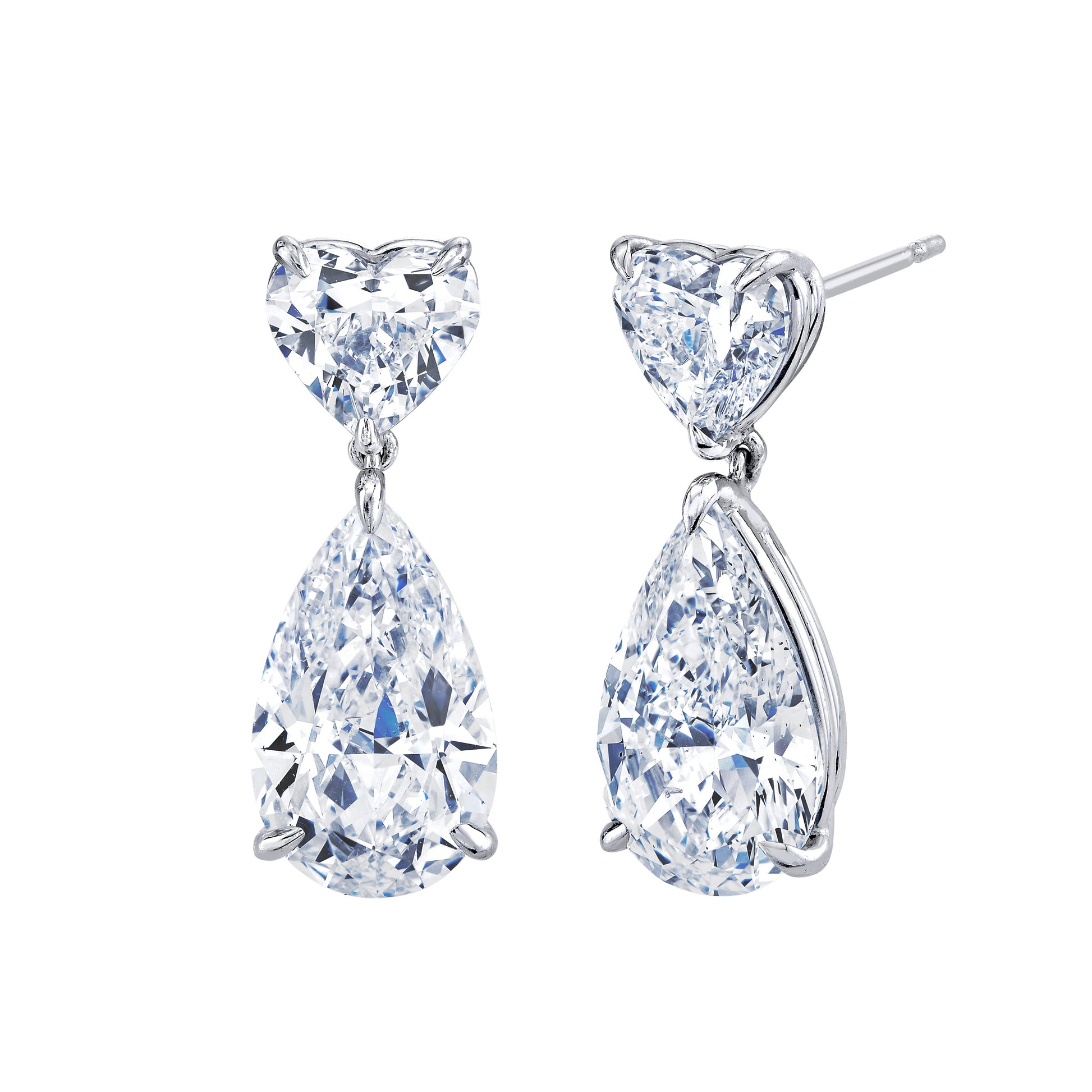 Pair of heart and teardrop-shaped diamond earrings on a white background