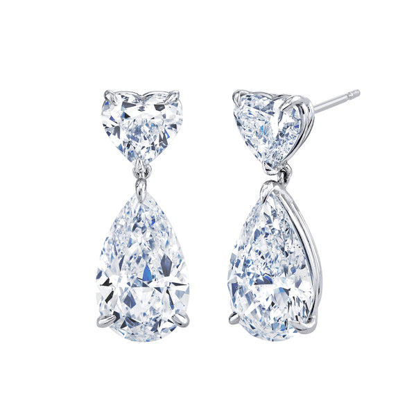 Pair of heart and teardrop-shaped diamond earrings on a white background