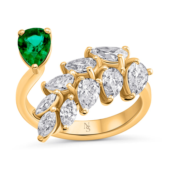 A leaf wrap diamond ring with an emerald accent, crafted in 18k yellow gold, featuring pear-shaped diamonds.