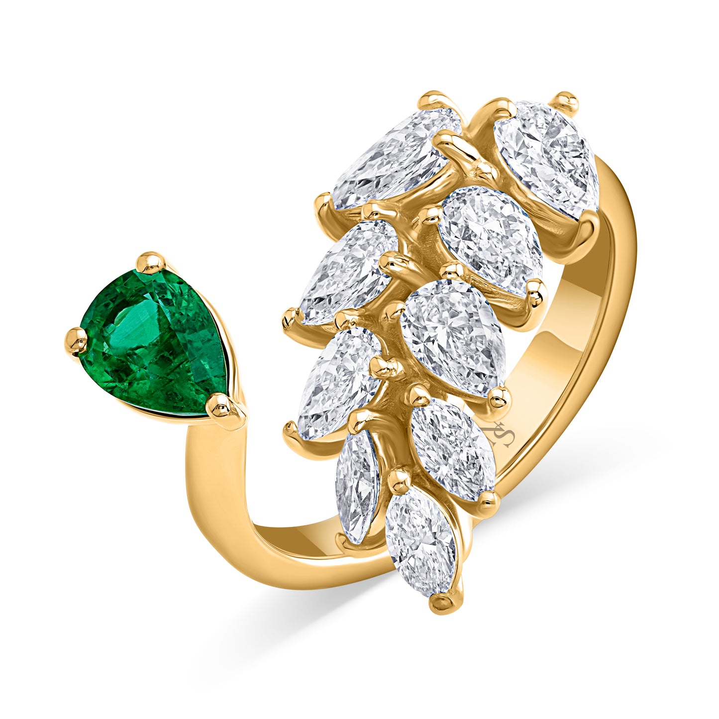 Leaf diamond bypass ring set in yellow gold with an emerald pear accent on a white background.