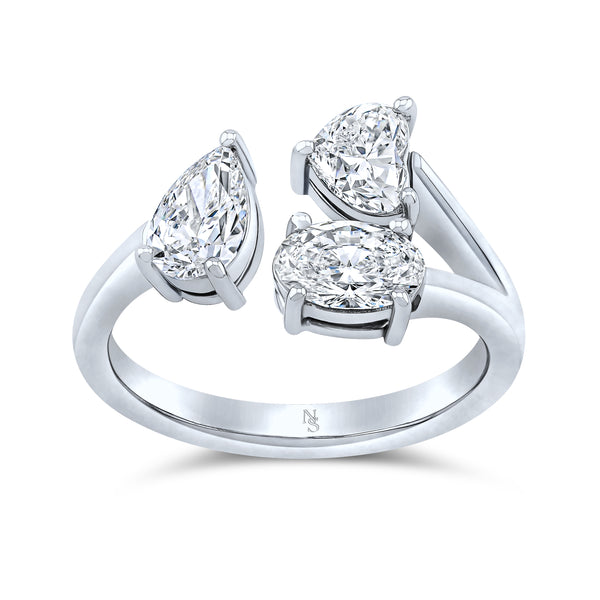A 18K white gold ring with mixed shape diamond cuts, showcasing a triple stone design.