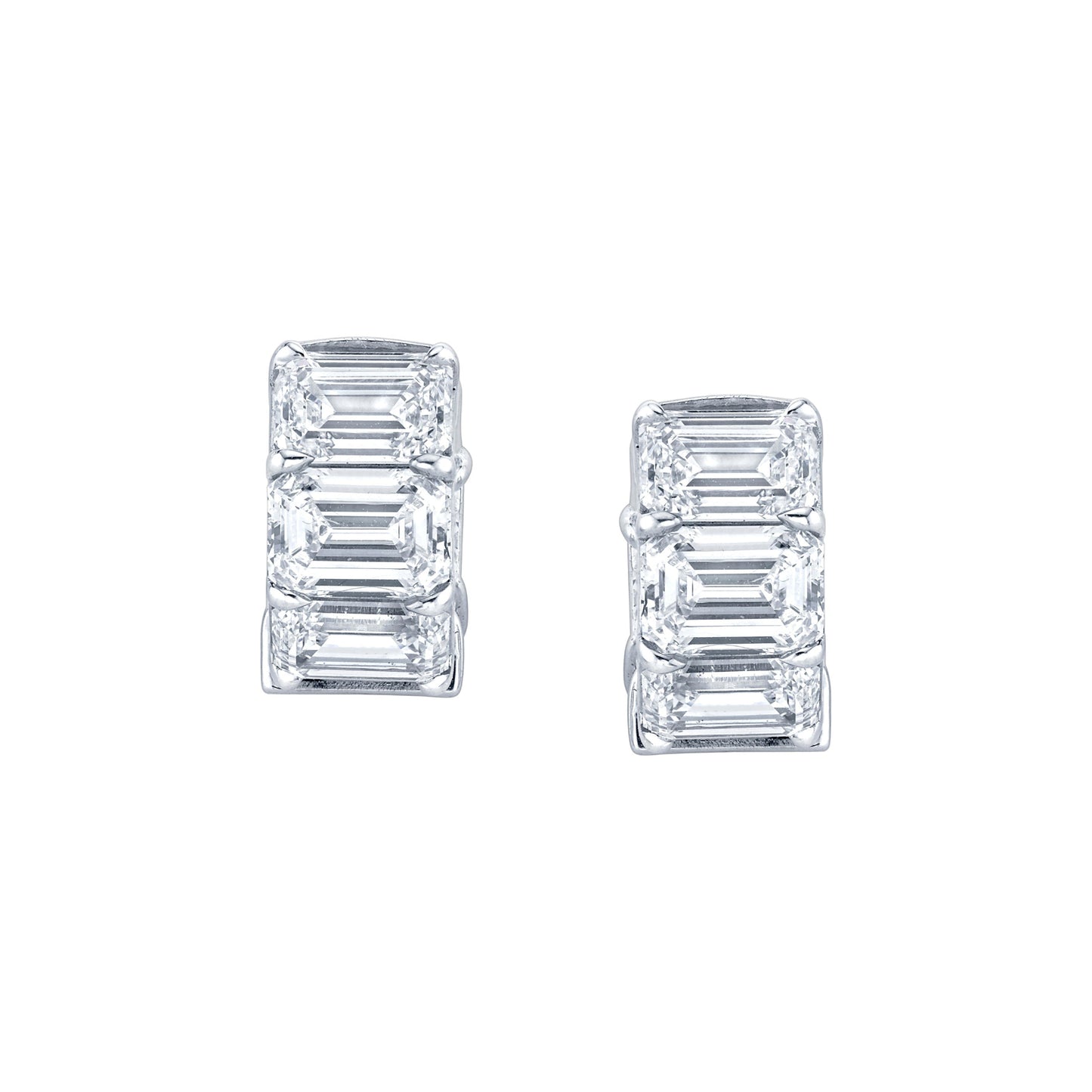 A pair of emerald cut diamond huggie earrings in 18k white gold.