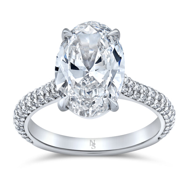 A 3.61 carat oval diamond ring with a pave band set in platinum.
