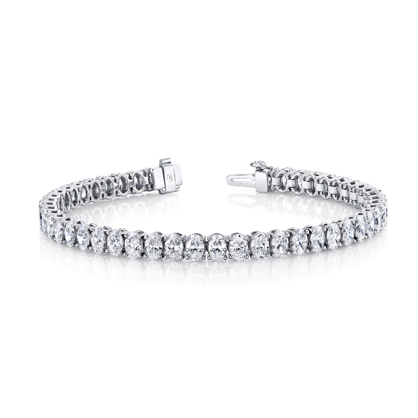 A white gold bracelet featuring oval cut diamonds set in a straight line design.