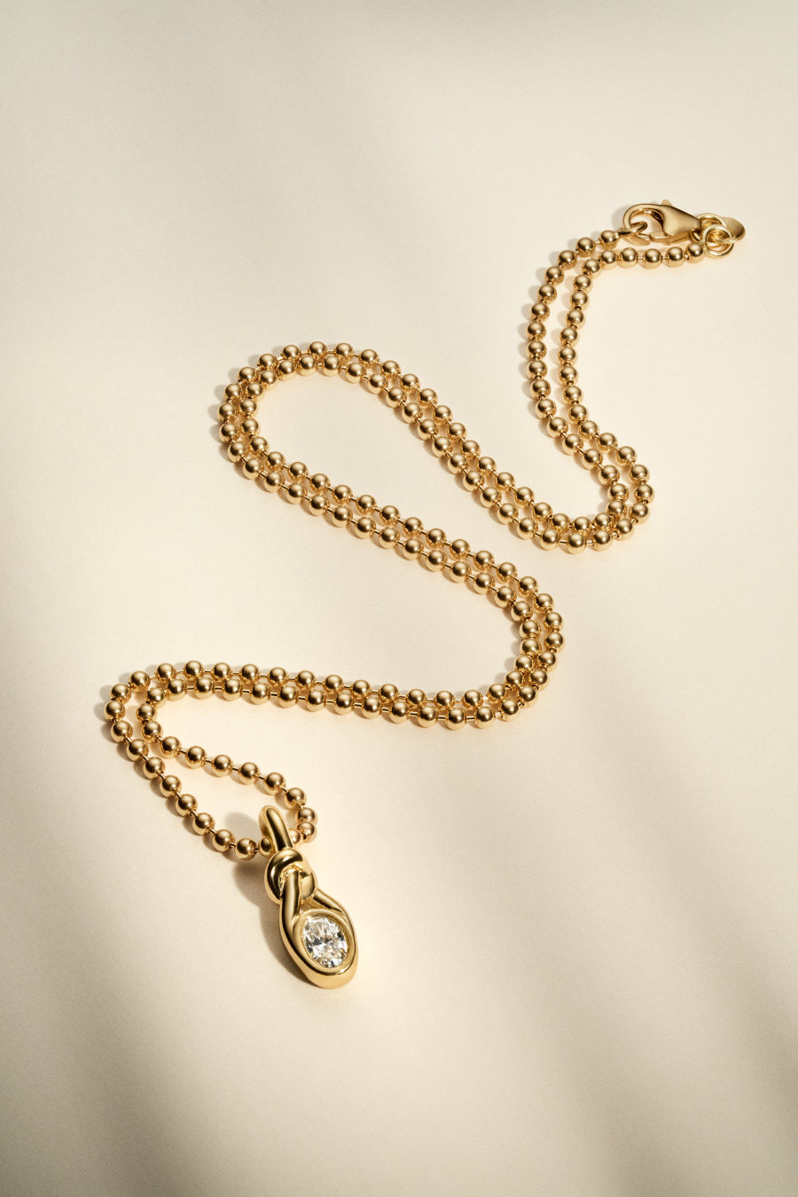 Oval Knot Bezel Diamond Pendant