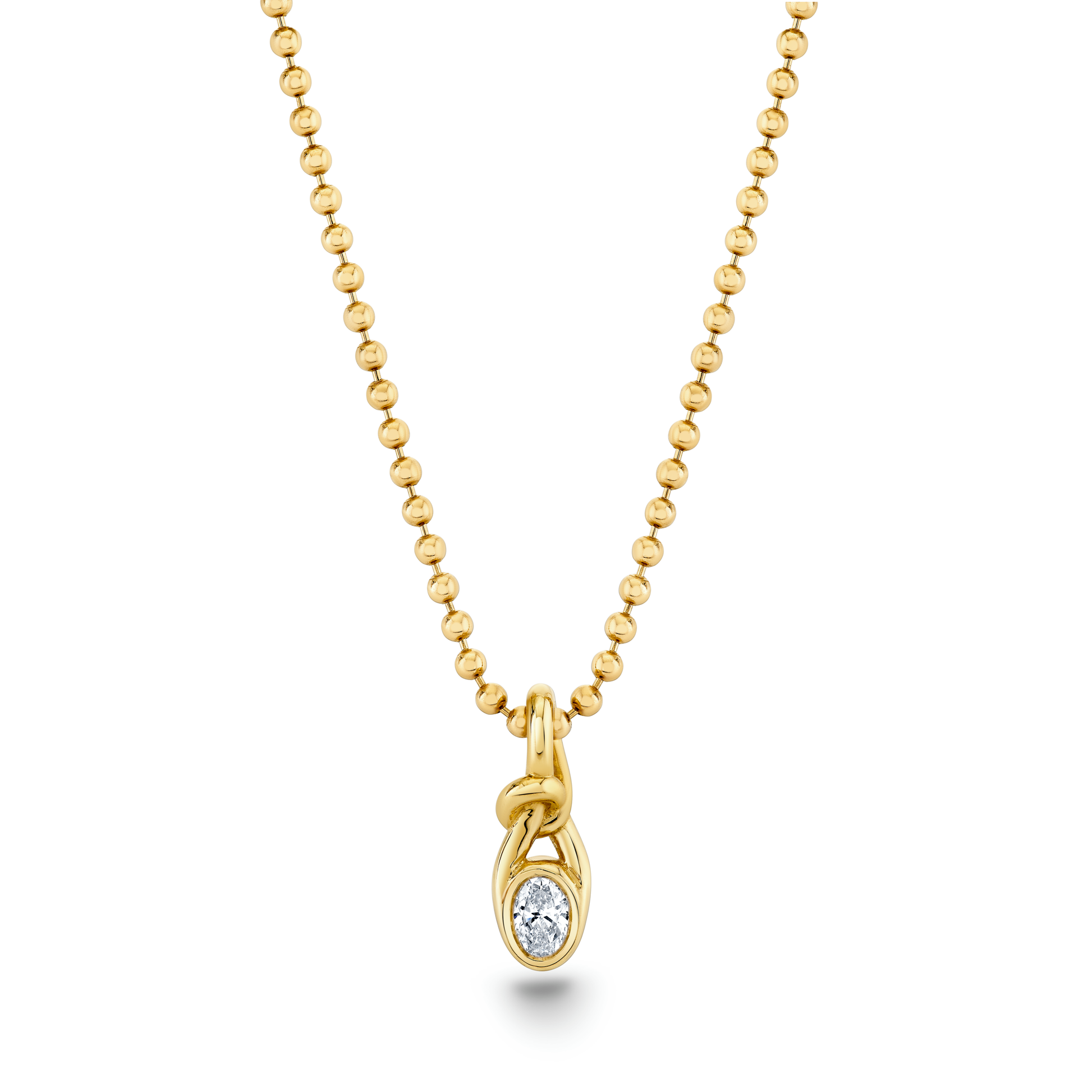 A gold oval knot pendant with a bezel setting containing a small diamond, attached to a gold ball chain by Norman Silverman