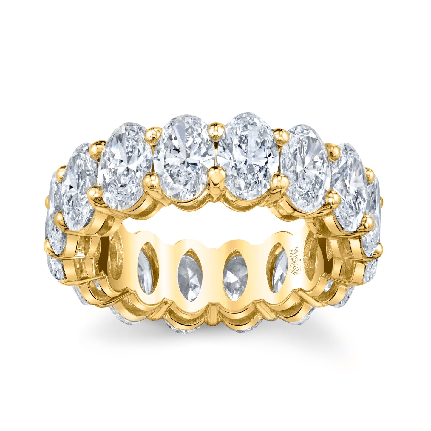 An oval diamond eternity band with multiple diamonds set in a gold band