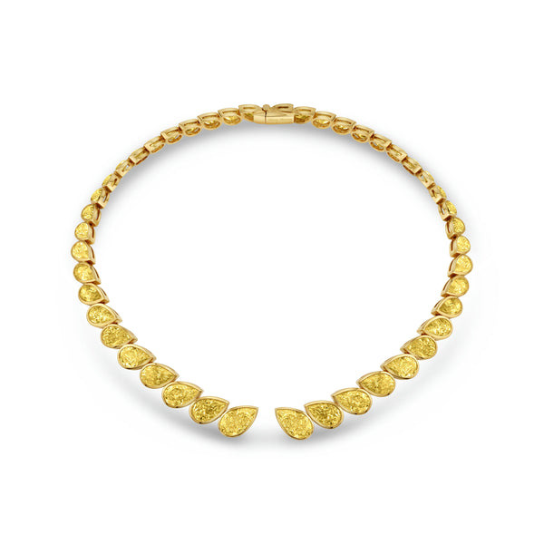 A yellow gold choker necklace with bezel set pear shape diamonds.