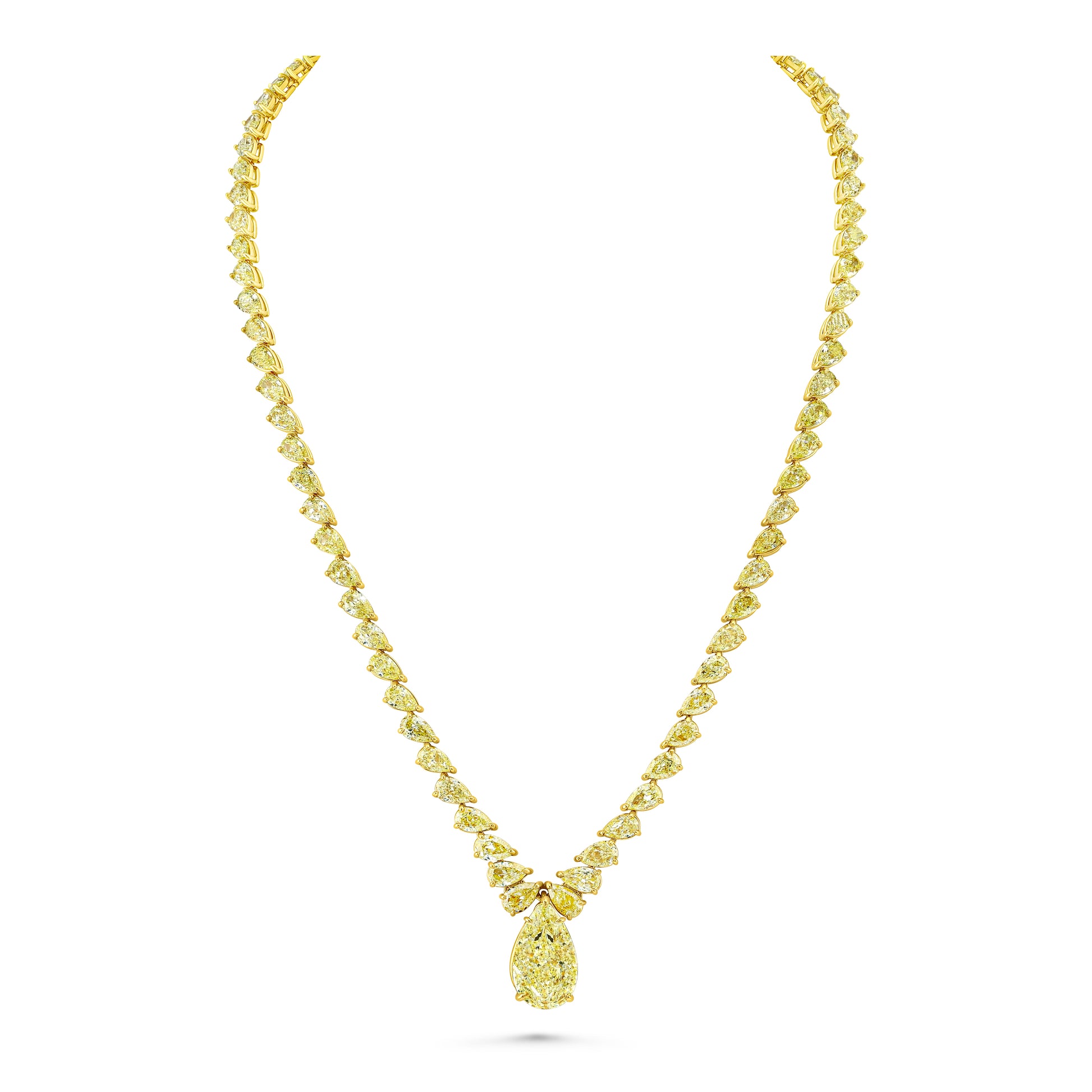 A yellow gold necklace featuring a fancy yellow pear lined chain and a pear shaped pendant, displayed on a white background.