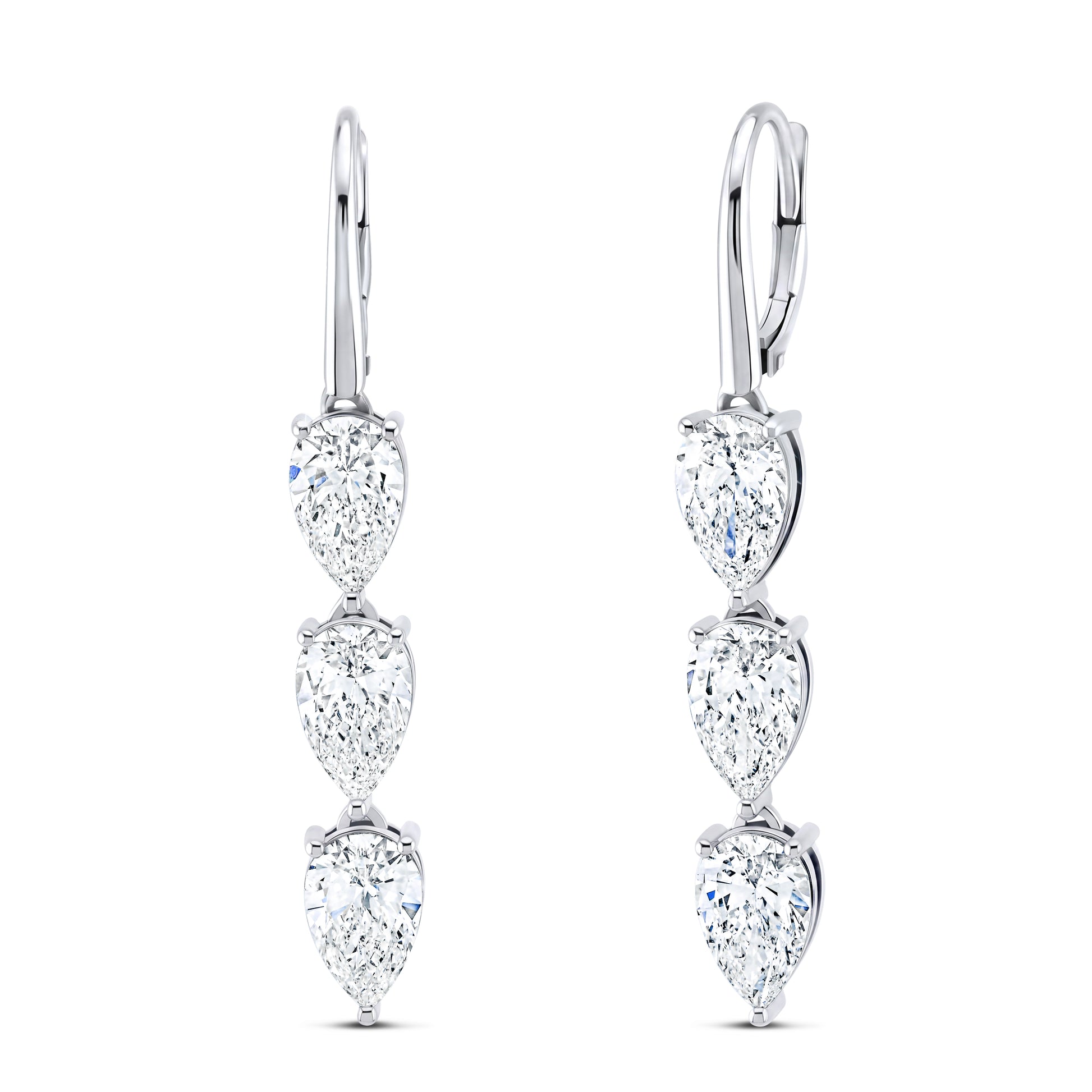A pair of white gold lever back earrings, featuring three vertically aligned pear-cut clear diamonds.