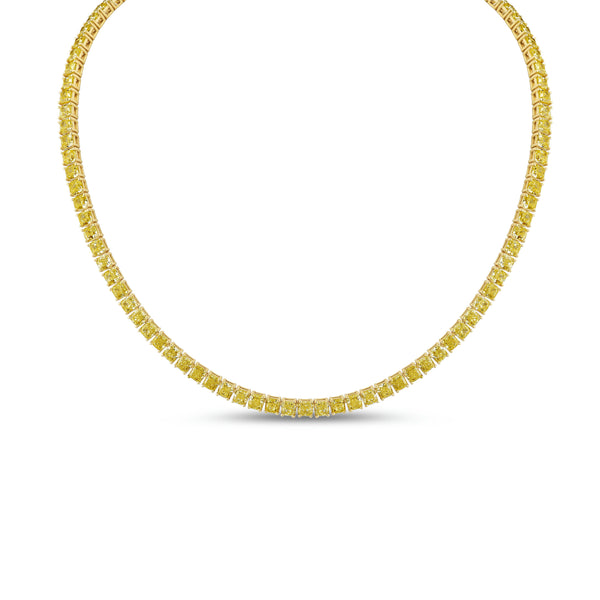 Fancy yellow radiant-cut diamond tennis necklace in yellow gold on white background.