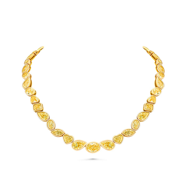 Gold necklace with mixed shaped yellow diamonds on a white background
