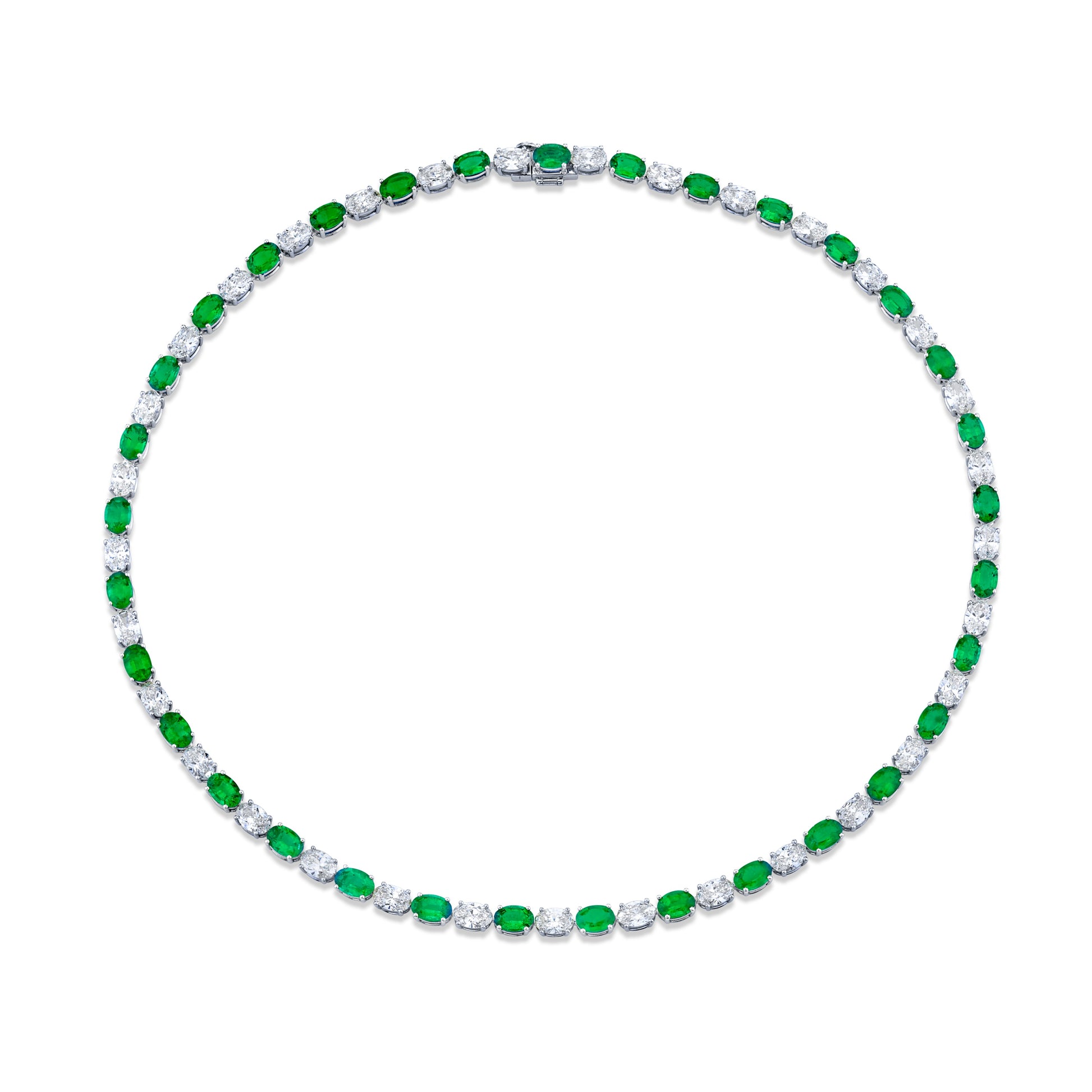 A necklace featuring a series of oval-cut diamonds and green emeralds, set in a white gold setting.