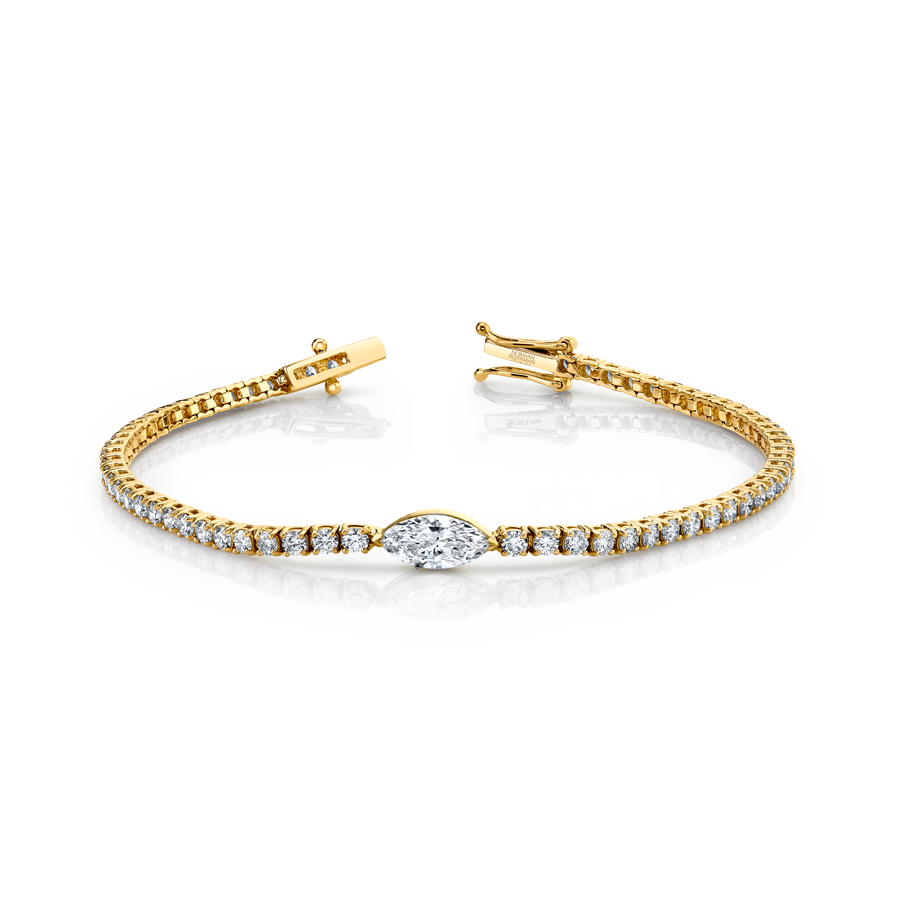 An 18k yellow gold straight-line diamond bracelet with a marquise-shaped diamond center.