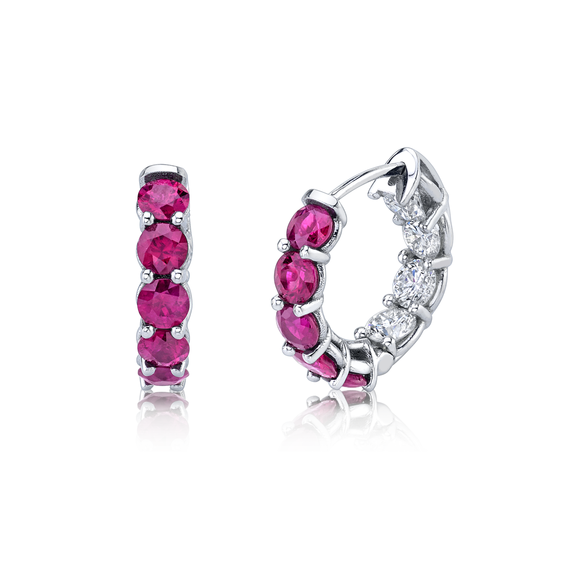 A pair of 18K white gold huggie earrings featuring round ruby and white diamond accents by Norman Silverman Los Angeles.