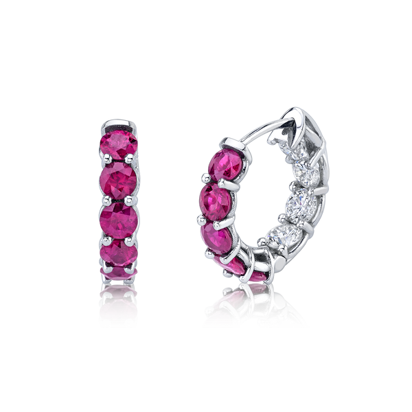 A pair of 18K white gold huggie earrings featuring round ruby and white diamond accents by Norman Silverman Los Angeles.