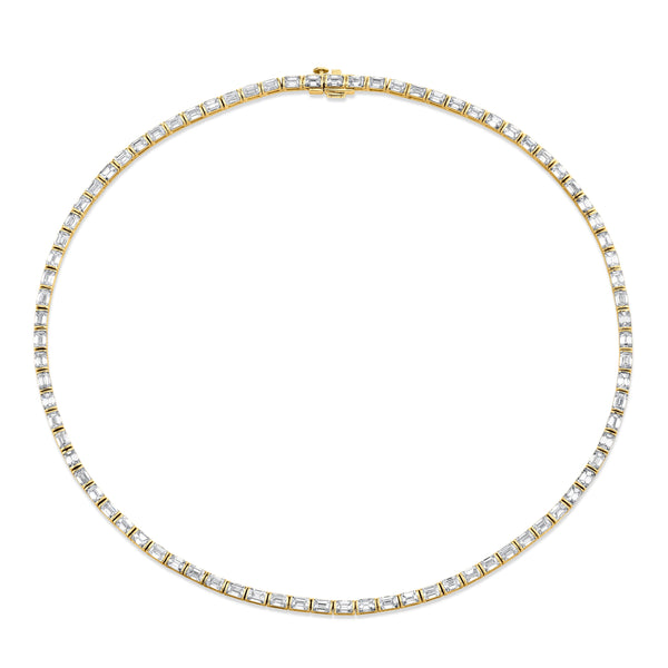 An 18k yellow gold emerald cut diamond bezel-set necklace with multiple diamonds set throughout.