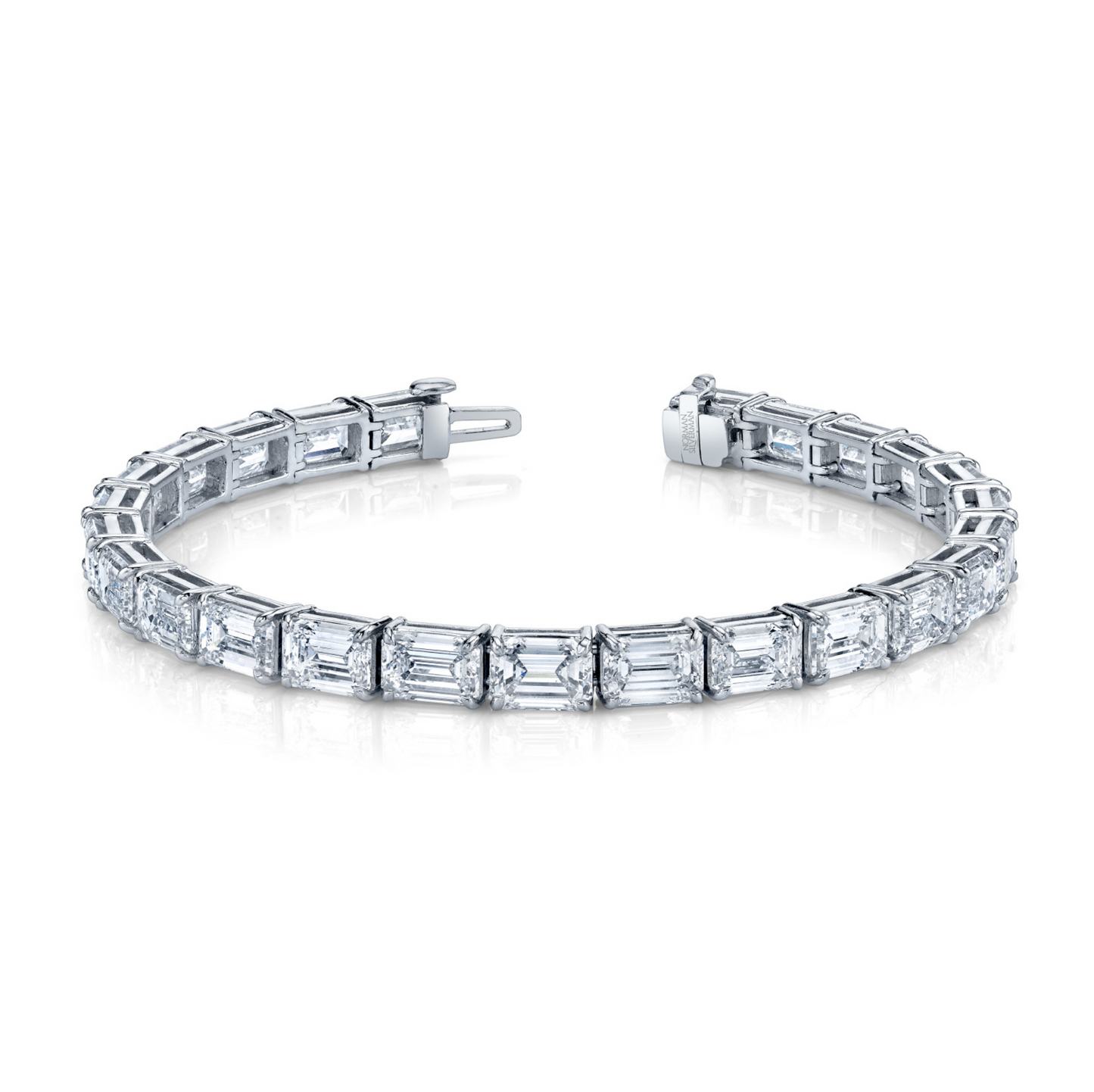 A straight line bracelet featuring emerald cut diamonds set in platinum.