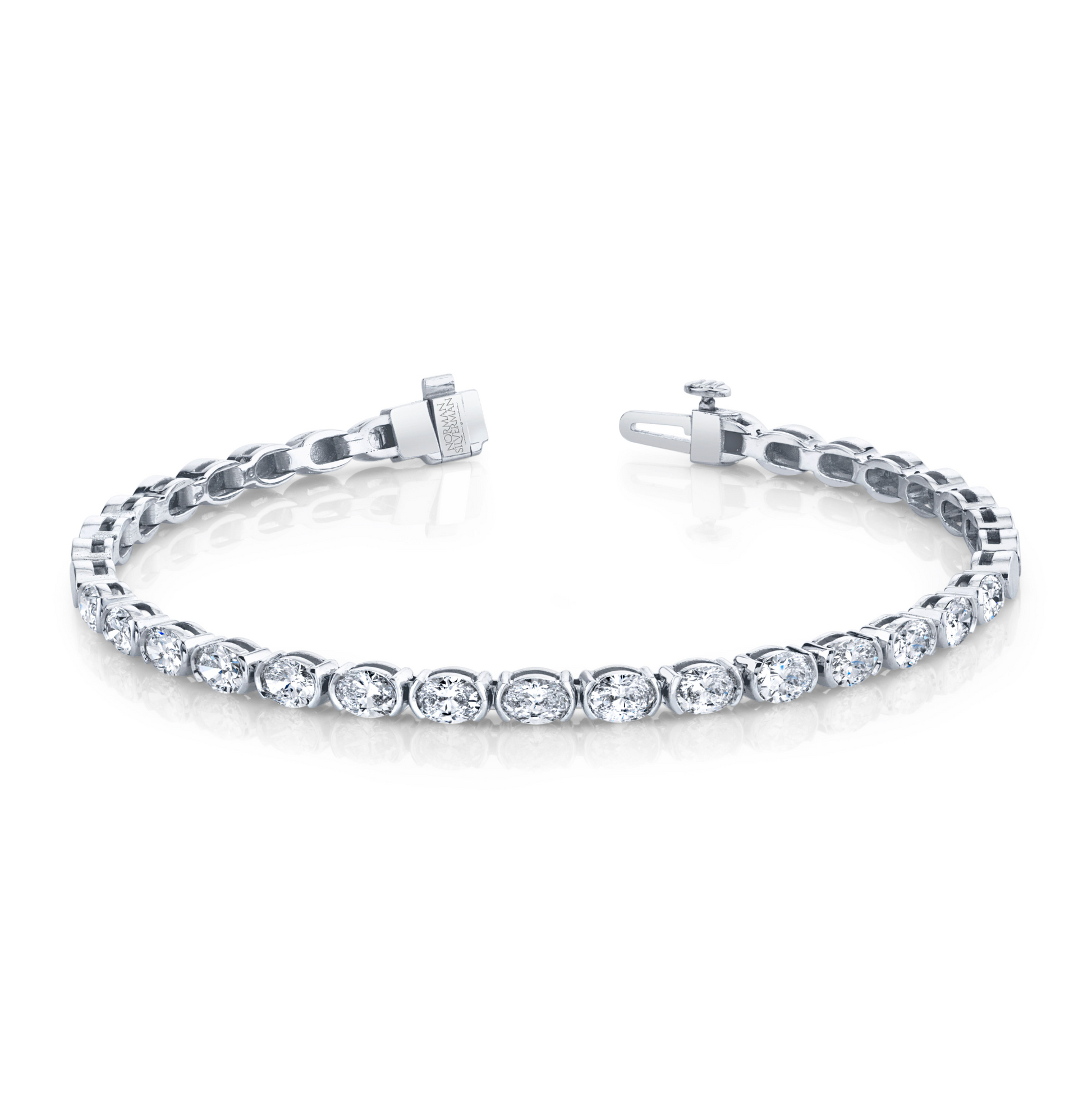 A tennis bracelet featuring almost 3 carats of brilliant oval diamonds, set in a metallic looking band, possibly gold.