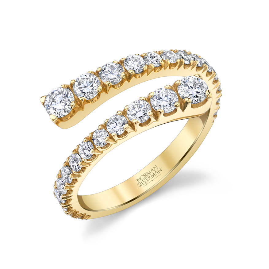 A bypass ring with graduated diamonds set in 18K yellow gold.