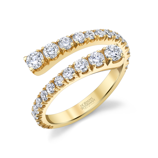 A bypass ring with graduated diamonds set in 18K yellow gold.