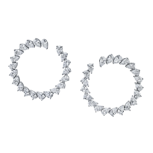 A pair of large 18k white gold hoop earrings with pear shaped diamonds set in a 3-prong arrangement.