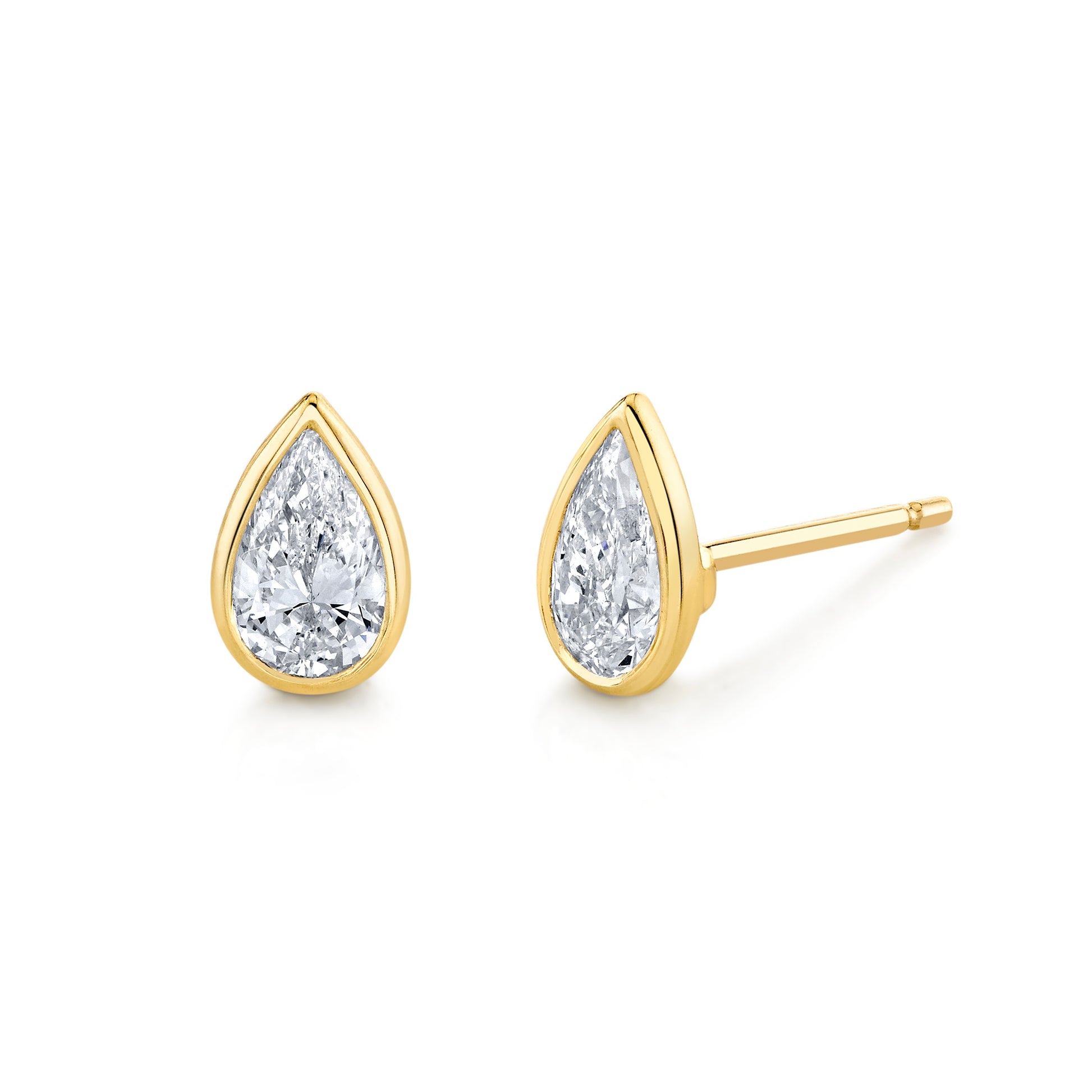 A pair of pear diamond bezel set stud earrings in 18k yellow gold.