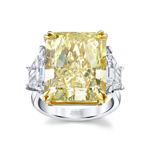 A Fancy Intense Yellow Radiant Diamond ring with trapezoid shaped side stones set.