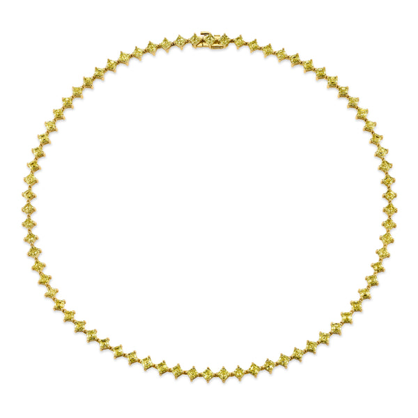 18k gold tennis necklace featuring a series of connected radiant yellow diamonds on a white background